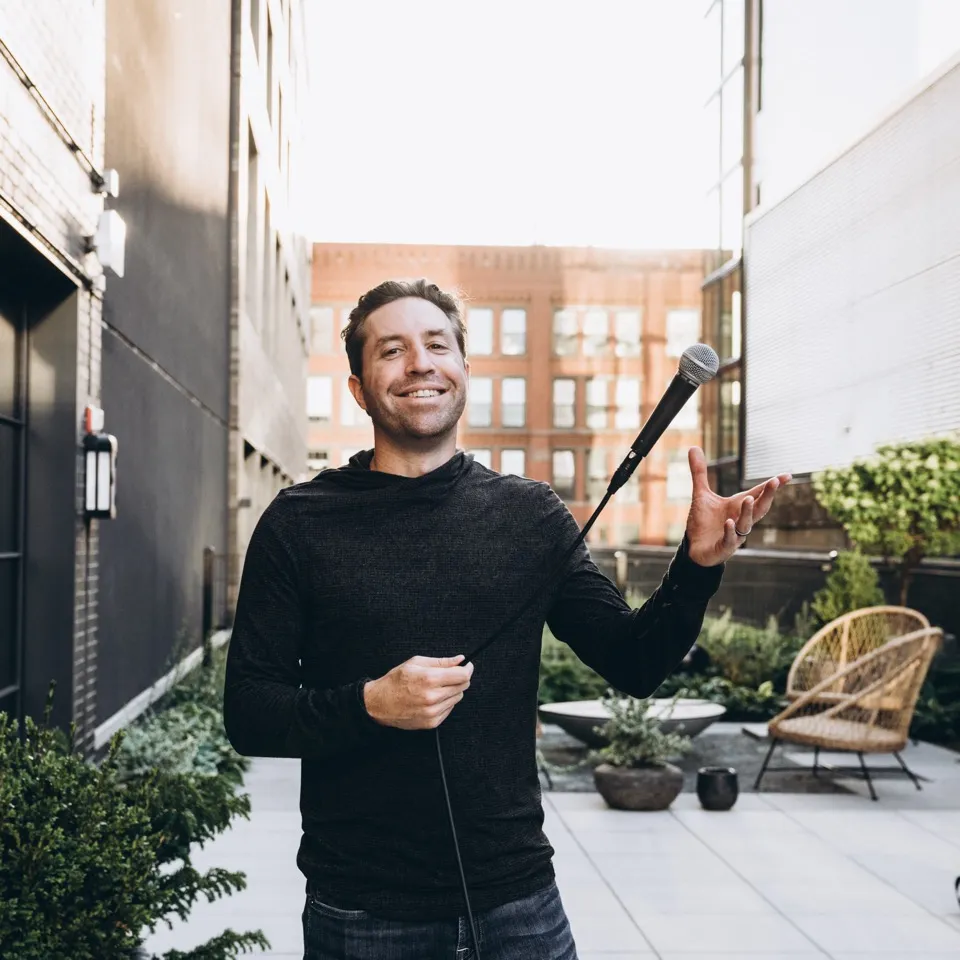 Rob Cressy speaking on stage with a microphone